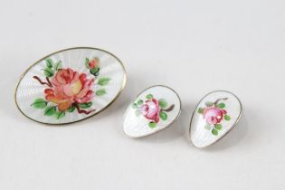A silver floral enamel brooch by David Anderson and a pair of similar earrings by Ivar Holth (8g)