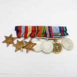 Selection of 7 medals all on one bar including Korea medal.