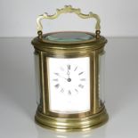 A large oval carriage clock by Thurlo 140mm x 120mm. Clock requires full service //