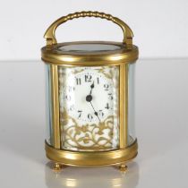 An oval midsized carriage clock. Clock runs but stops. Requires full service 115mm x 90mm //