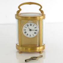 Oval midsized carriage clock. Clock runs. 115mm x 90mm //