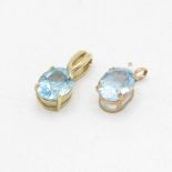 2x 9ct gold oval cut blue topaz pendants (2g)