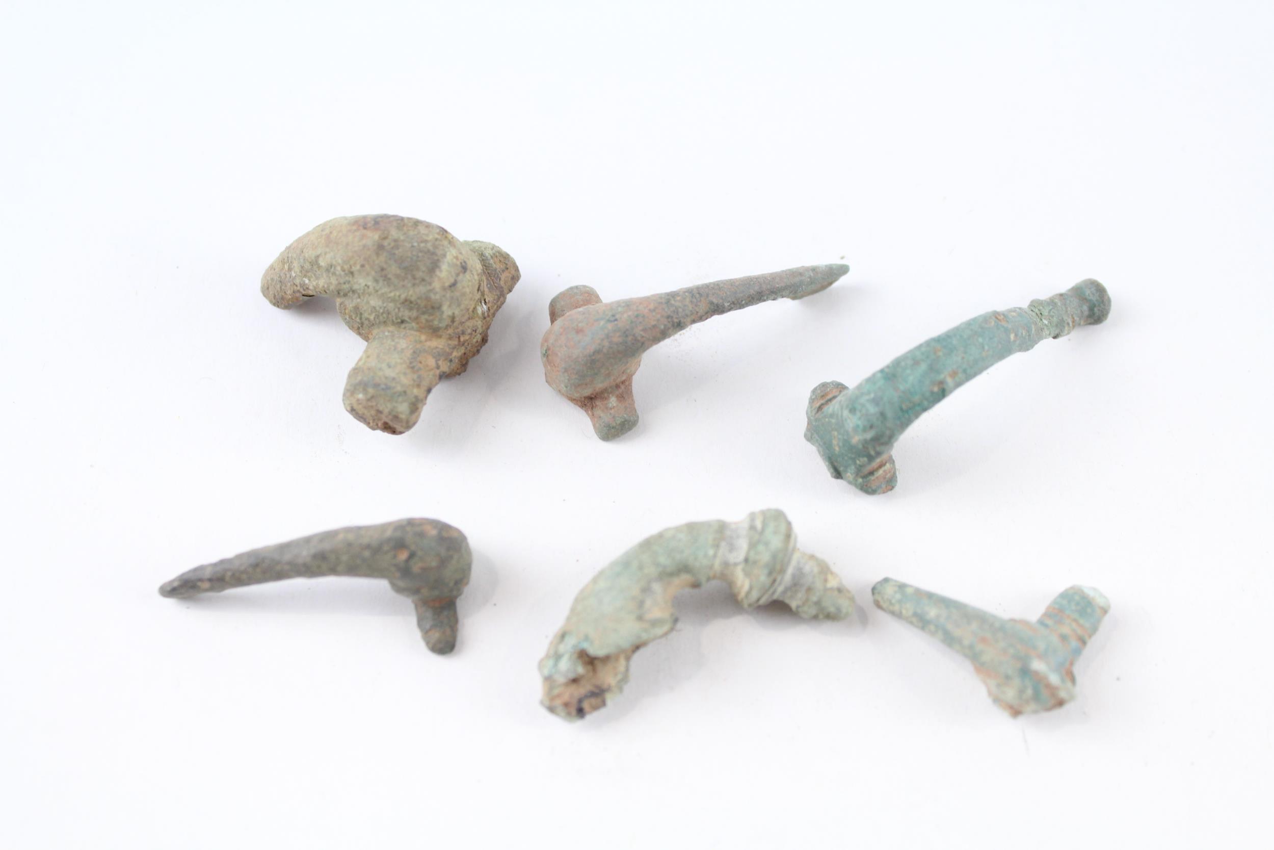 A collection of partial Roman trumpet brooches archaeological metal detectorist finds (g)