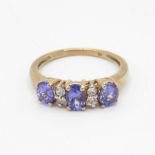 9ct gold oval cut tanzanite three stone ring with white sapphire dividers (2.4g) Size O