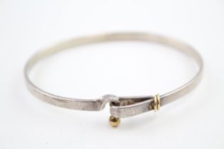 A silver bangle by Tiffany and Co with 18ct gold detailing (12g)