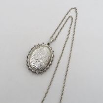 Antique locket in silver with silver chain - chain measures 60cm long - locket is 45mm long 29g