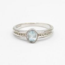 9ct white gold oval cut blue topaz & diamond ring , total diamond weight 0.10ct approximately Size N