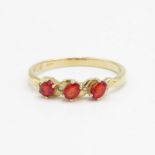 9ct gold red gemstone three stone ring with white gemstone accent Size T 2 g