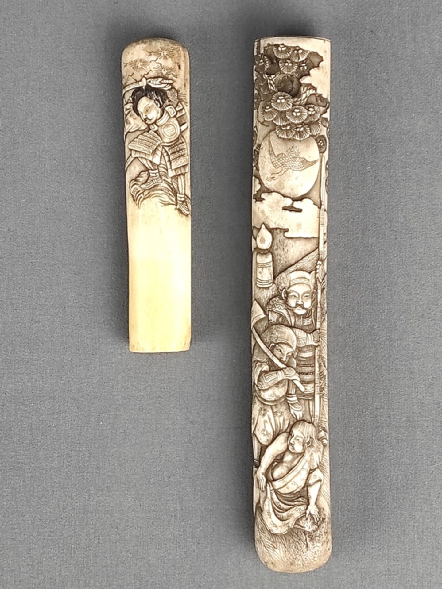 Knife sheath/case, probably Japan, with samurai depictions in relief in front of a landscape, consi - Image 2 of 2