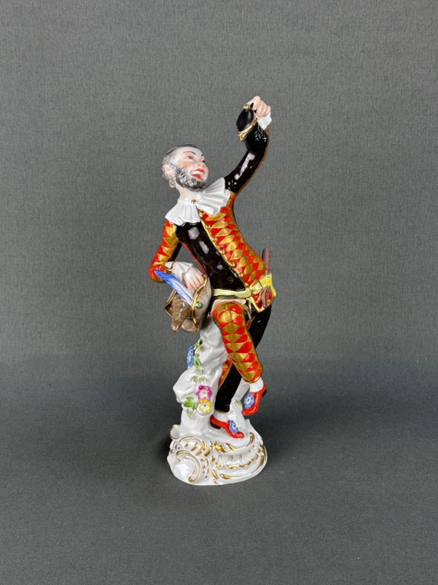 Porcelain figure "Harlequin with lidded jug", Meissen crossed swords mark, from the "Commedia dell'