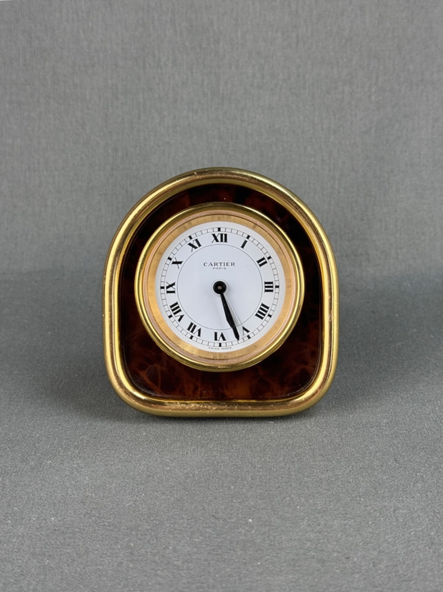 Table clock with alarm function, Cartier, Swiss made, brass case, manual winding, front and verso m