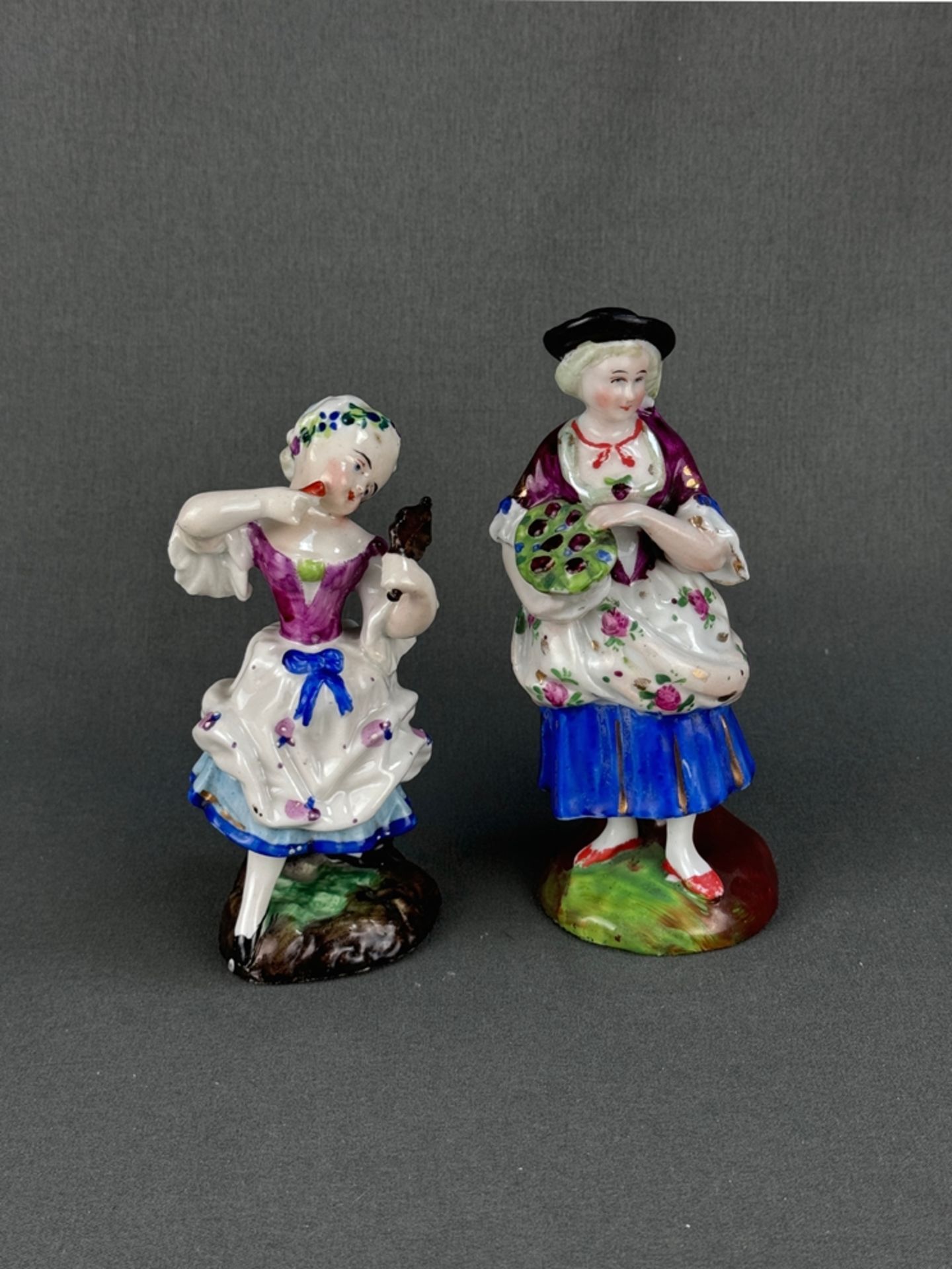 Two porcelain figurines "Woman with mirror" and "Woman with basket of flowers", polychrome hand-pai