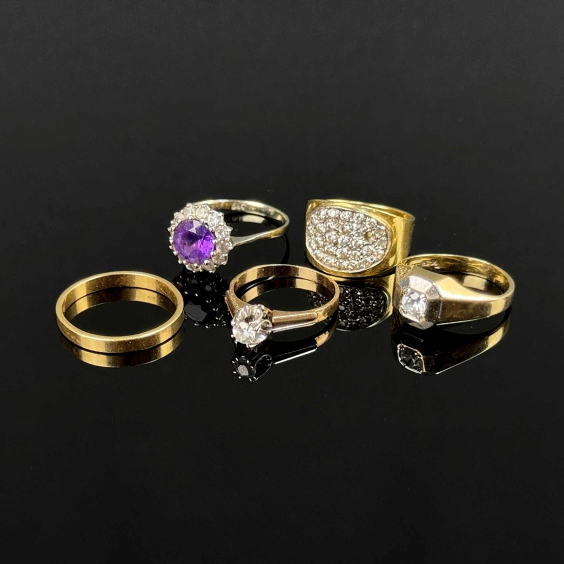 A collection of five rings, one ring with large zirconia, 333/8K yellow gold, 3.27g, ring size 58, 
