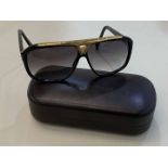 LOUIS VUITTON, a pair of Italian, gilt mounted, black framed sunglasses