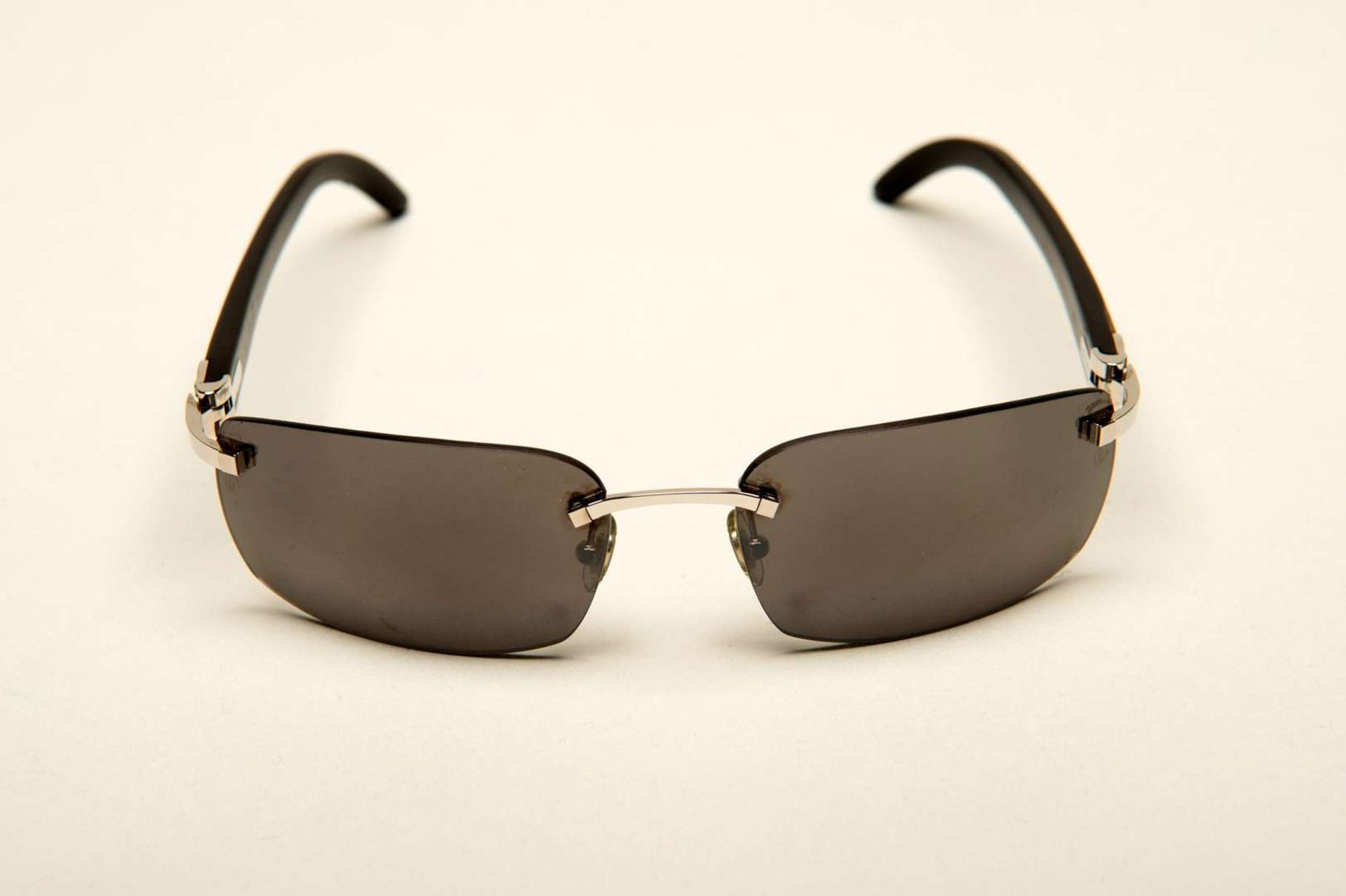 CARTIER, a &nbsp;pair of French rimless, horn armed sunglasses