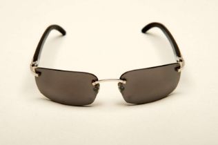 CARTIER, a &nbsp;pair of French rimless, horn armed sunglasses