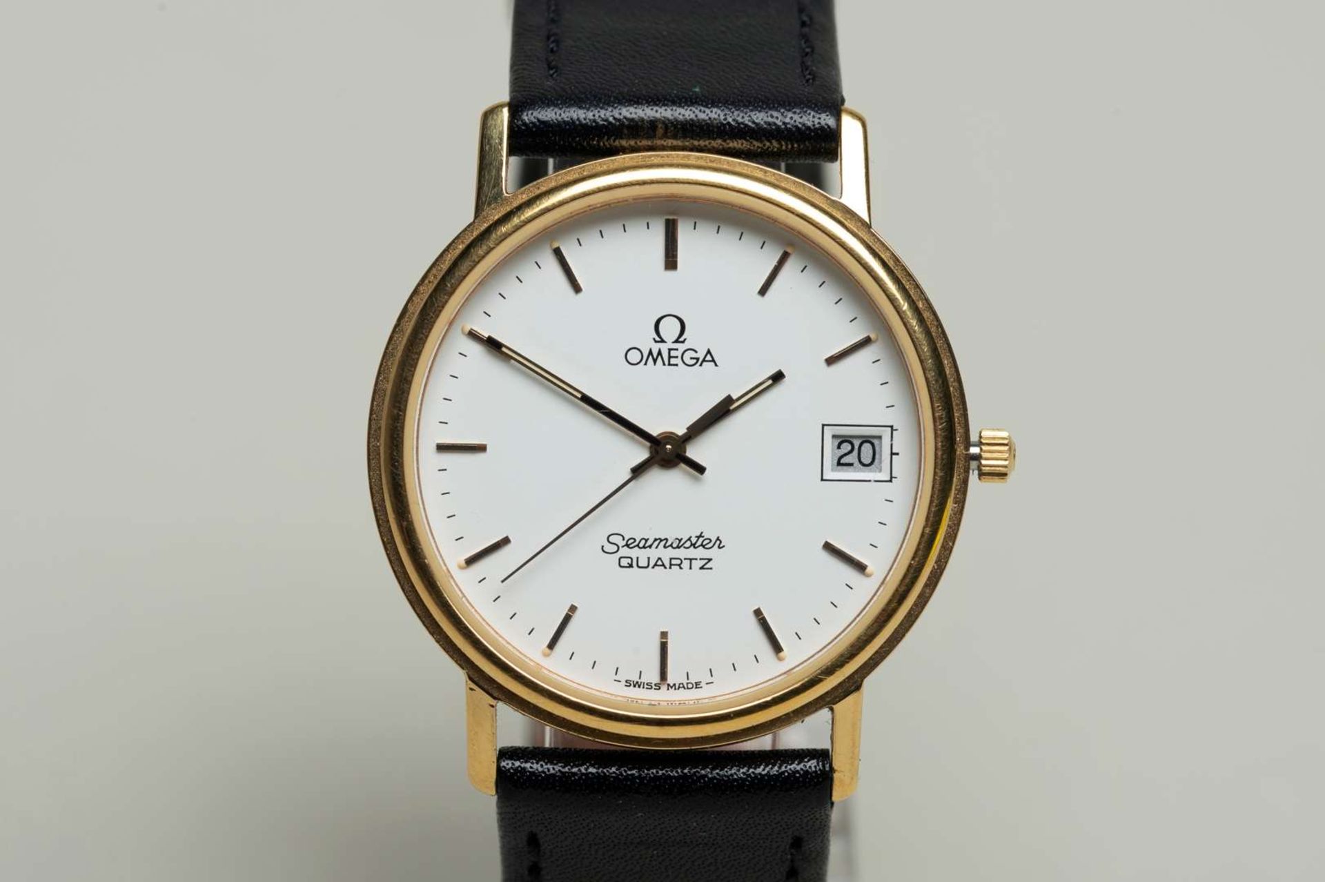 OMEGA, a modern gold plated, quartz, centre seconds, calendar wristwatch.