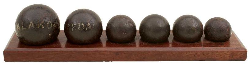 A DISPLAY OF SIX CRIMEAN WAR CANNON BALLS AND SHRAPNEL BALLS,