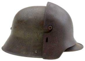 A FIRST WAR GERMAN M1916 HELMET AND ARMOURED FOREHEAD PLATE,