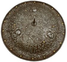 AN ITALIAN EMBOSSED SHIELD IN THE MILANESE RENAISSANCE STYLE,