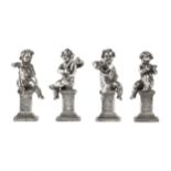 Four funny figures of putti musicians in silver.