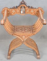 Fauteuil „Dagobert“. Wohl Italien 20. Jh. Massivholz, teilw. geschnitzt, mit Horn- und Zinneinlagen.