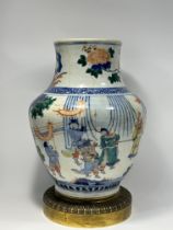 A Large Chinese Bulbous Wucai vase, painted of a scene of legendary warriors practising archery, gla