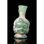 ROMAN GREEN GLASS UNGUANTARIUM HEAD SHAPED