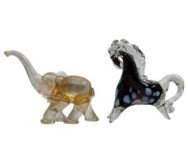 2 glass objects, 2 Moreno glass objects, one in the shape of a horse and the other in the shape of