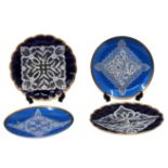 4 porcelain plates, decorated with white enamel in a lace napkin pattern and a gold saying on blue