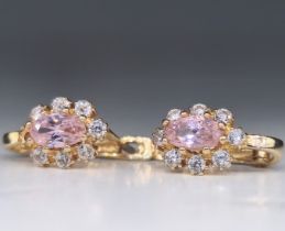 A pair of earrings, made of 14 carat yellow gold. Studded with zircons. Height of the inlaid front