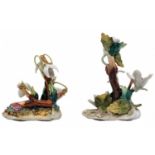 A pair of European porcelain figurines, in the form of vegetation, foliage and fruit, decorated with
