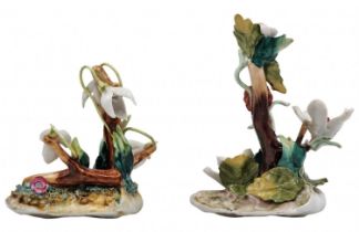 A pair of European porcelain figurines, in the form of vegetation, foliage and fruit, decorated with