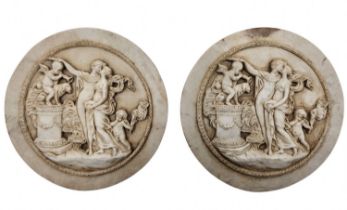 A pair of antique style decorative medallions, made of cast reconstituted marble. Diameter: 16 cm.