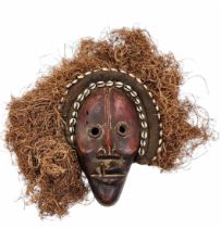 Ancient African mask - Dan People, made of carved wood and plant fibers, decorated with shells