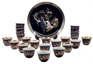 Japanese porcelain set, is decorated with flower and bird prints on a cobalt blue background and a