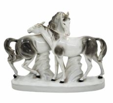 A large porcelain statue in the form of two horses, decorated with hand painting, not signed.