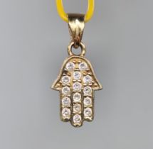 A small hamsa pendant, made of 14 carat yellow gold inlaid with zircons, signed. Width: 8 mm Height: