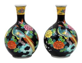 A pair of Chinese porcelain jugs, from 'Famille Noir', decorated with hand-painted enamel, signed.