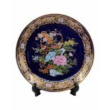 A large Japanese porcelain plate, decorative, decorated with a print of peacocks, flowers and gold