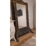 A large and impressive antique mirror (floor mirror)., made of carved wood, glass with a phase,