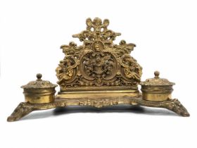 A beautiful antique double desk inkwell, apparently French, made of cast brass, two wells, paper