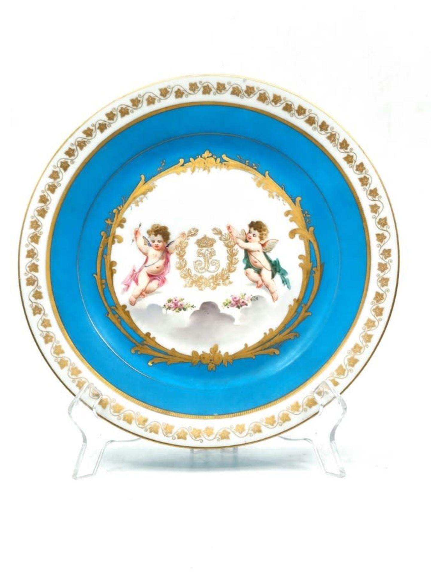 An antique French porcelain plate made by 'Sevres', made in 1876, decorated with hand paintings in