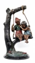 'Children on a swing' - a decorative bronze statue, colored patina, stepped black marble base,
