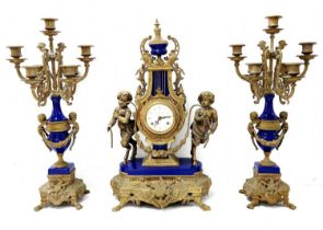 Antique Italian garniture, made of brass and blue porcelain, includes a mantle clock and two