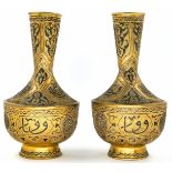 A pair of Islamic vases, decorated with 'Damascus work' (inlay of copper and silver in a brass),