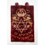 A Torah scroll coat, embroidered with cotton threads on red velvet, dating from 1929, the subject of