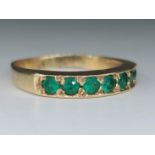 An antique 14K gold ring with 7 emerald stones, not signed but the purity of the gold has been