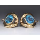 A pair of 14K gold earrings with polished blue topaz stones, signed, Total weight: 5.44 grams total,