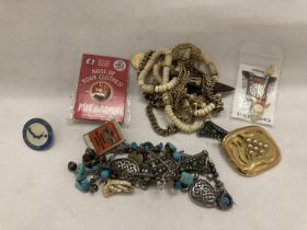 A QUANTITY OF COSTUME JEWELLERY AND BADGES TO INCLUDE A RING, BRACELET, NECKLACES, CHAINS, ETC